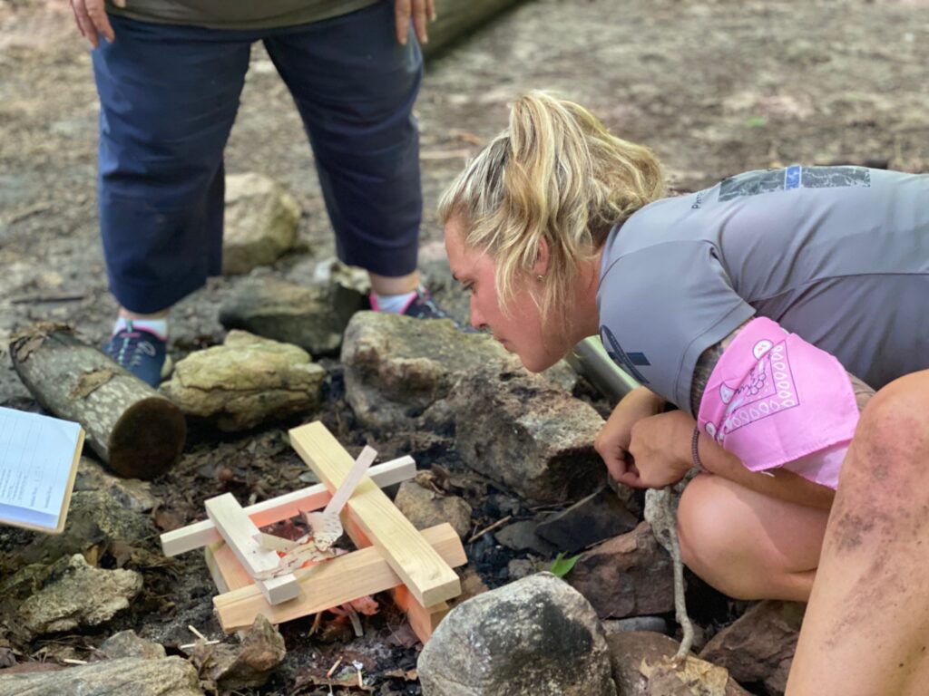 Team Building Survivor Woman building a fire