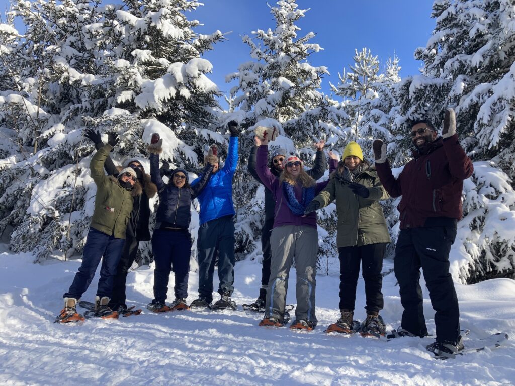 Snowshoeing Snowshoers with hands in the air