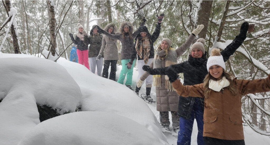 IMG_1832 A group of women fanned out on a snowy hill with smiles and arms held wide open
